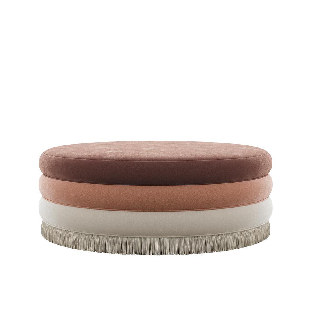 Wide Audrey bench or oversized stool by Ottiu, featuring large stacked velvet discs in cocoa, salmon, and cream, finished with a thick cream-colored fringe.