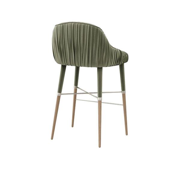 45º back view of the Gardner bar chair upholstered in Piti fabric by Casamance, showcasing a wavy green pattern reminiscent of sand dunes, flowing water, or wood grains, and finished with elegant lacquered legs.