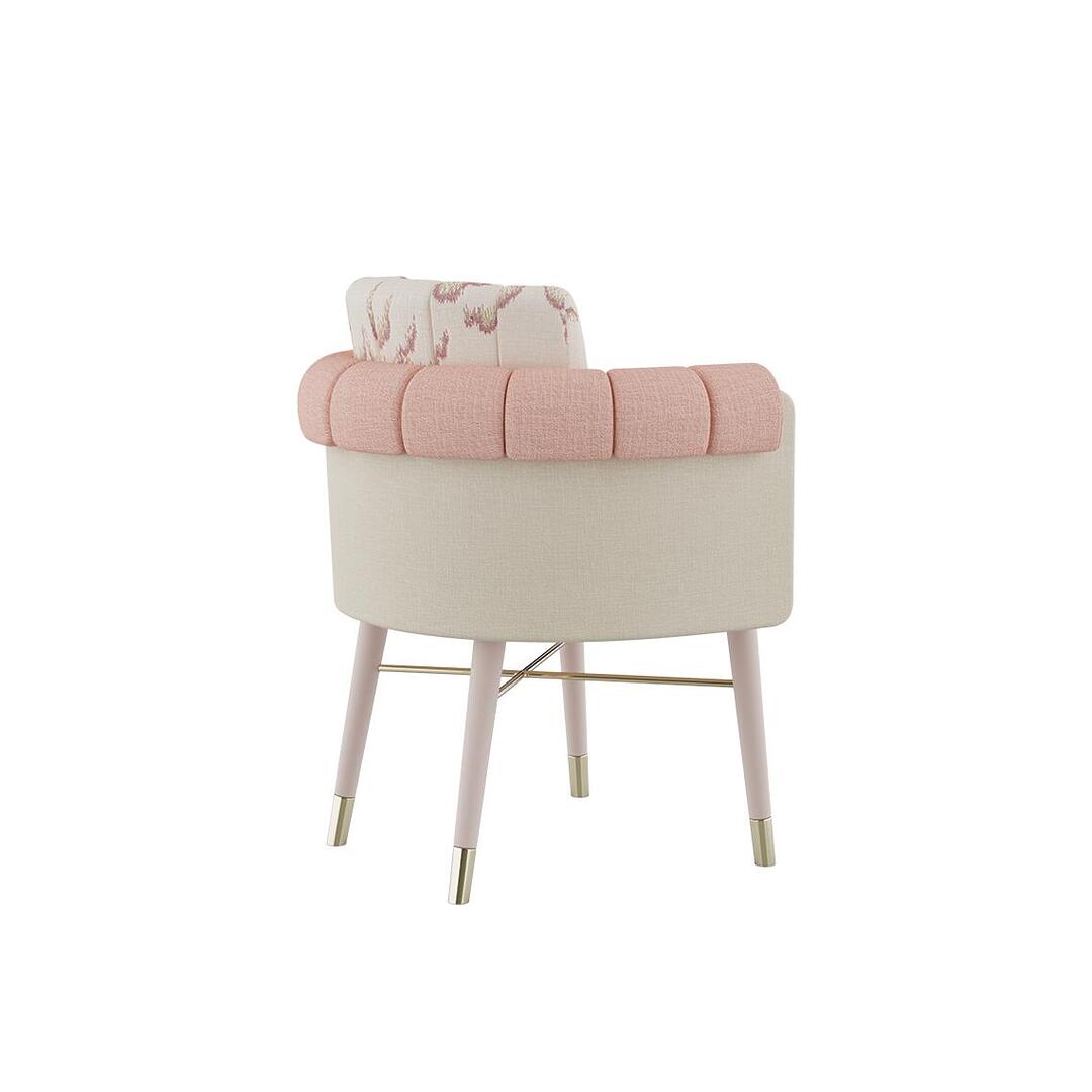 Helen dining chair shown from a 45º back angle, dressed in plain wool fabric by Dedar with a patterned weave, supported by white lacquered wood legs and embellished with polished brass accents.
