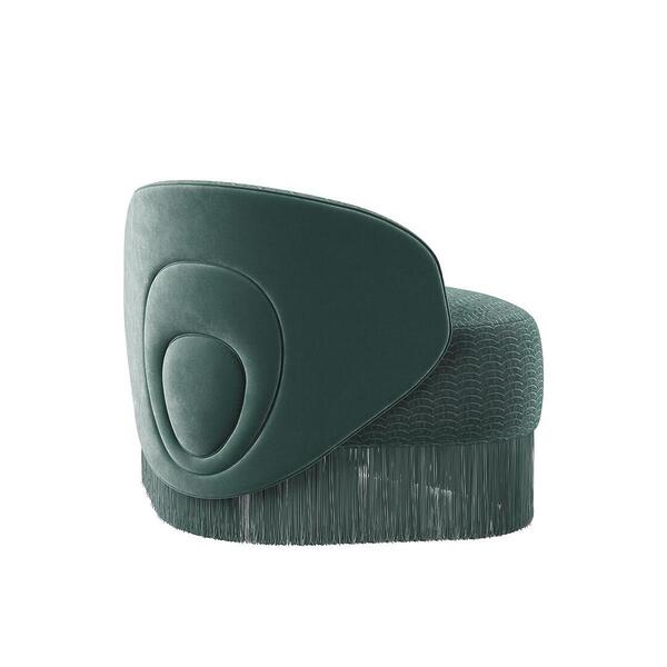 Doris armchair shown from a 45º back angle. The piece highlights a lavish composition, exquisitely hand-upholstered in sumptuous turquoise velvet fabrics, elegantly draped with cascading fringes that exude grandeur. Upholstered in Dedar fabrics: Ripley and Plushy.