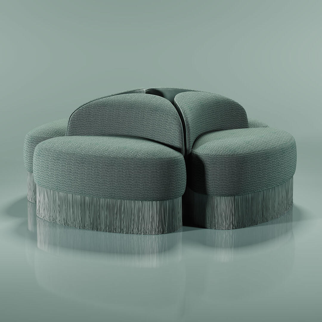 Four Doris armchairs placed back to back against a turquoise background. The design reveals a lavish composition, exquisitely hand-upholstered in sumptuous turquoise velvet and adorned with cascading fringes that exude grandeur. Finished in Dedar fabrics: Ripley and Plushy.