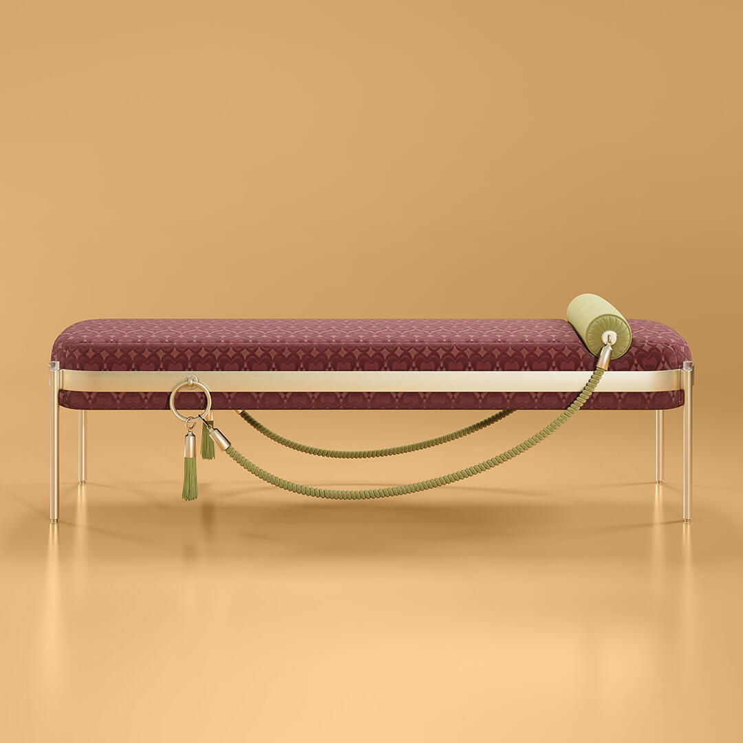 Ginger Bench upholstered in Hearts Ruby by Kirkby, a Bordeaux heart-shaped pattern, set against an orange background.