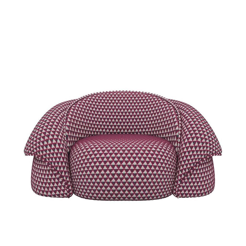 Romy armchair upholstered in Amuleto 008 by Dedar, a jacquard velvet with brilliant, light-catching colours that plays with the geometric perfection of the triangle, repeated infinitely.