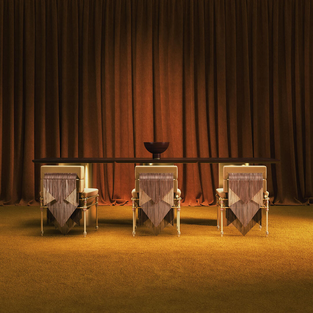 Trio of Seraphine dining chairs adorned with rose fringes and brass legs, staged on a yellow carpet with a rich red curtain creating a bold, theatrical backdrop.
