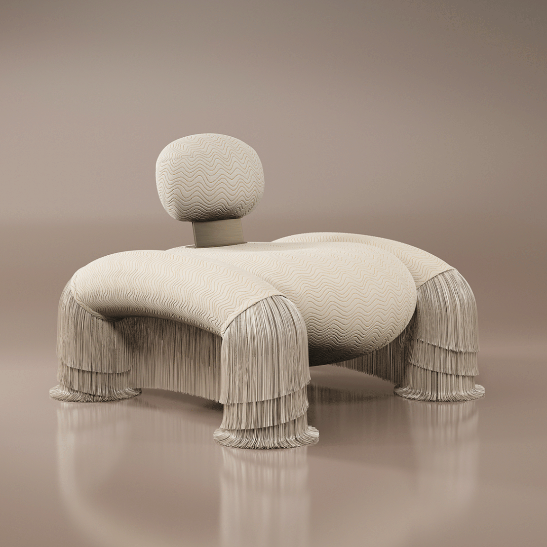 45-degree front view of the Odessa Armchair with a dynamic backrest that moves up and down, featuring fringes, upholstered in cream, paired with aged brass, set against a cream background.