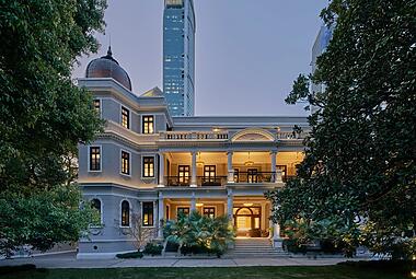 Ottiu Beyond Upholstery Exterior view of Mi Shang Prada Rong Zhai, a 1918 heritage mansion in Shanghai meticulously restored by Prada and transformed into a cinematic dining space through a collaboration with director Wong Kar Wai, blending Eastern and Western design elements.