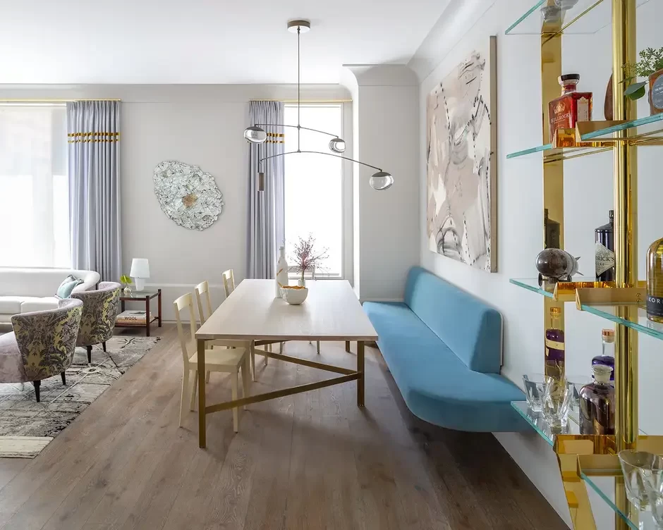 banquette-seating-Mise-en-Scène-Design Built-in banquette seating with upholstered cushions along a dining nook, paired with a wooden table and accent pillows, creating a cozy and space-saving dining area.