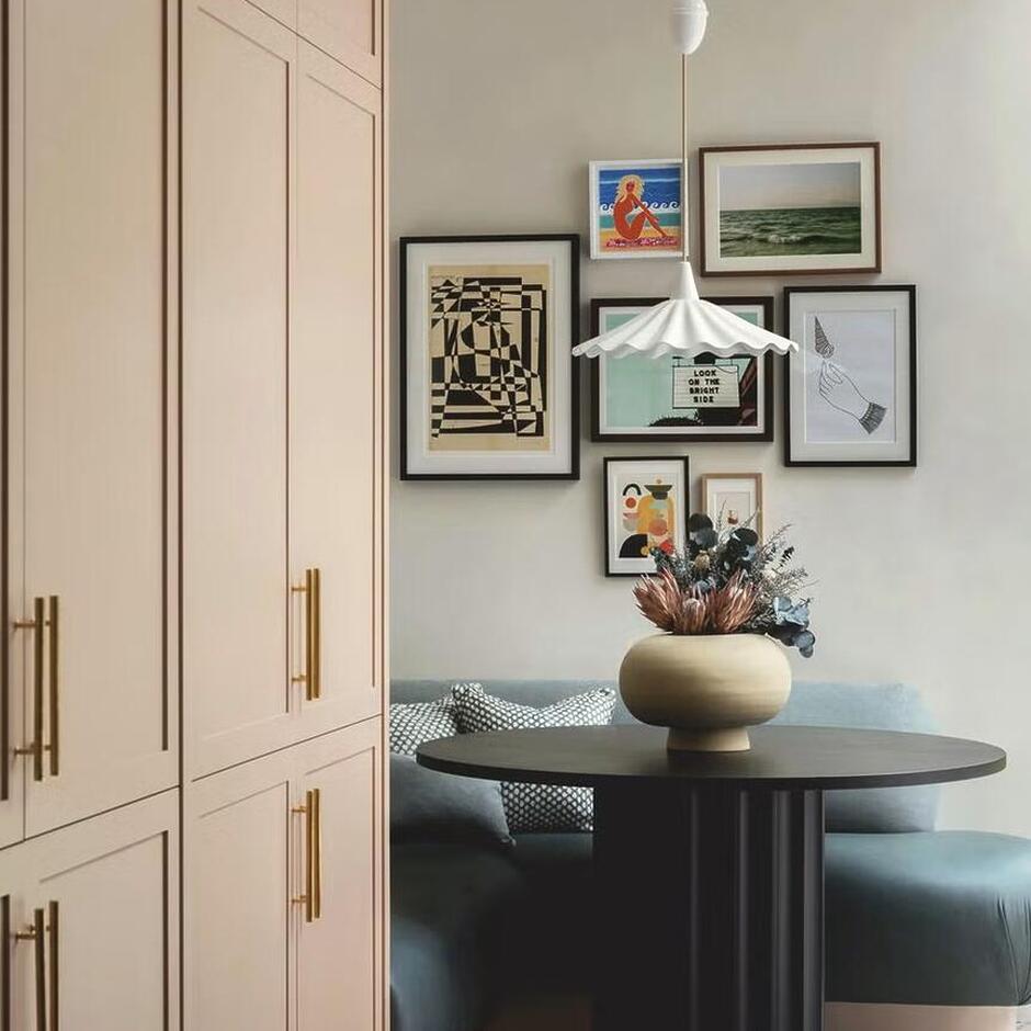 banquette-seating-studio-duggan-house-london Built-in banquette seating with upholstered cushions along a dining nook, paired with a wooden table and accent pillows, creating a cozy and space-saving dining area.