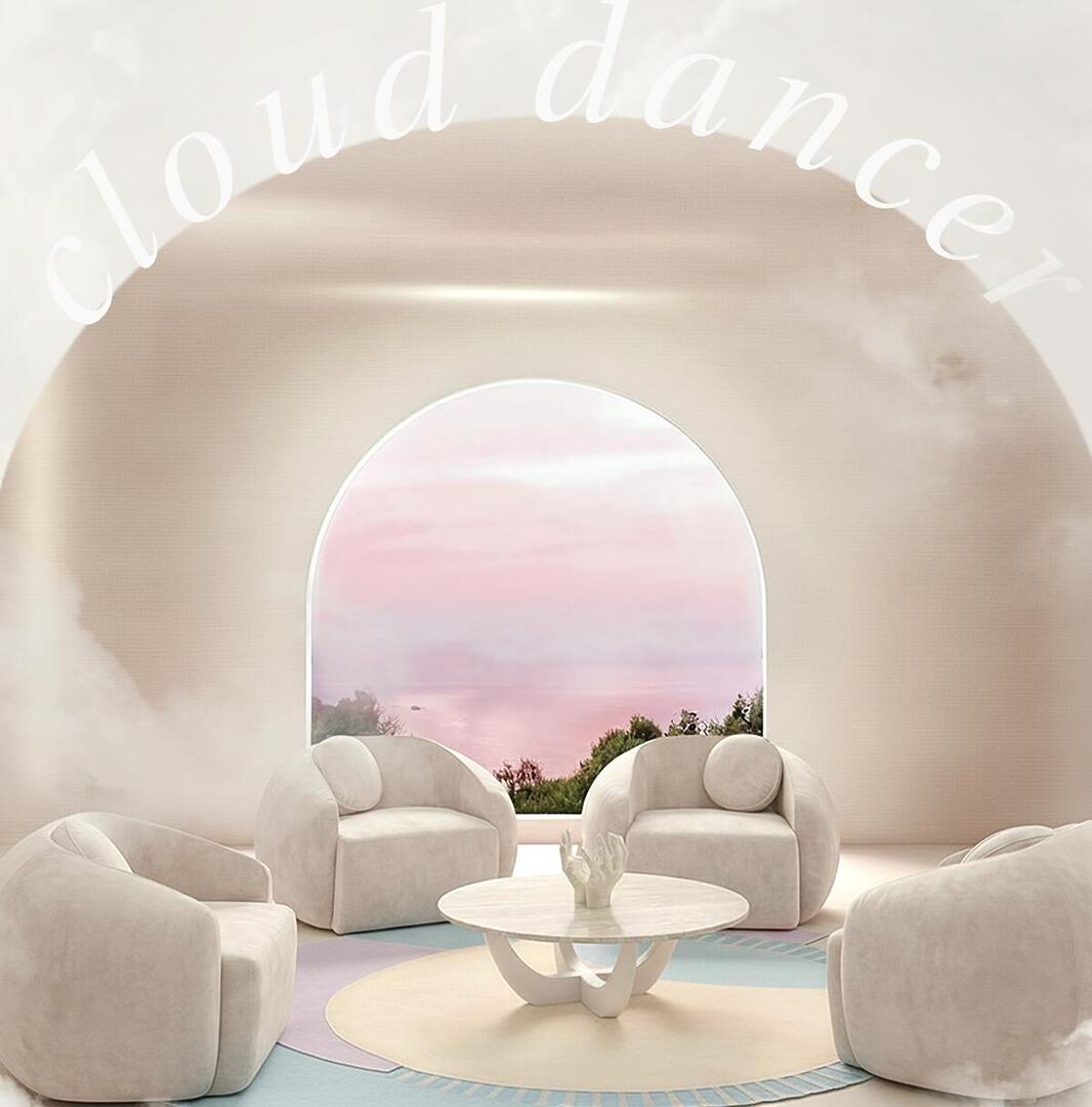 Four Peggy Armchairs upholstered in white fabric, reflecting the new Pantone 2026 color Cloud Dancer, arranged around a center table