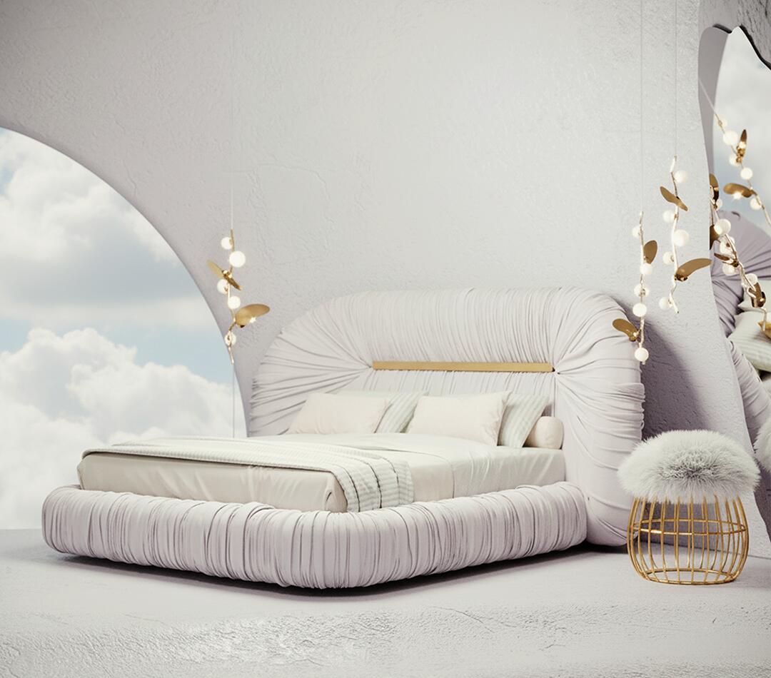 Tammi bed upholstered in Cloud Dancer within a dreamy, cloud-filled interior, accompanied by the Andy Stool and Almond pendant lamps.