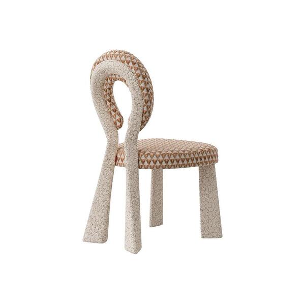Three-quarter rear view of the Mary Dining Chair featuring a sculptural open-back. The chair is upholstered in a cream bouclé frame paired with a seat and backrest in a sophisticated white and terracotta triangular geometric pattern.
