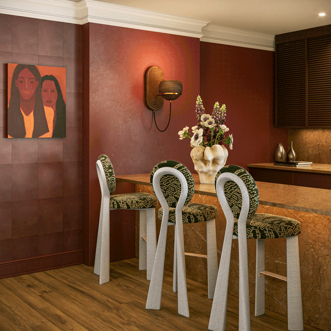 Three Mary Bar Chairs, captured with cinematic drama, lined up at a brown marble counter in a sophisticated, warm-toned interior. The chairs feature an avant-garde design with textured white frames forming a unique loop backrest, complemented by dark green upholstery with a golden abstract pattern and metallic footrests. The elegant background includes rich terracotta walls, a modern portrait painting, a decorative wood-and-metal wall sconce, and a sculptural vase with flowers. Dramatic lighting, soft shadows, and a cinematic atmosphere enhance the scene, creating a sense of depth, elegance, and visual storytelling.