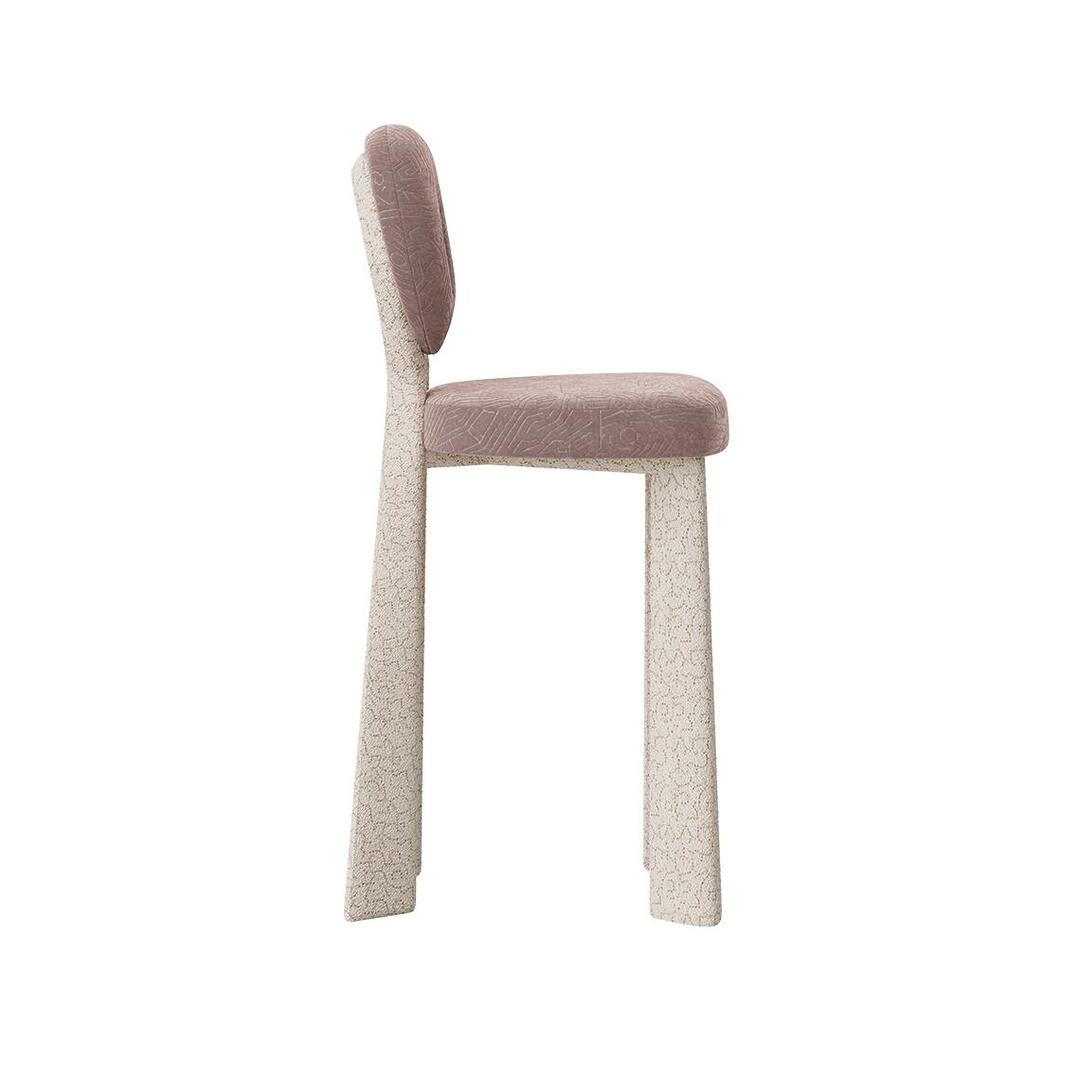 Profile view of the Mary Bar Chair, displaying the lean, architectural lines of the bouclé-covered legs and the comfortable thickness of the patterned velvet seat and backrest.
