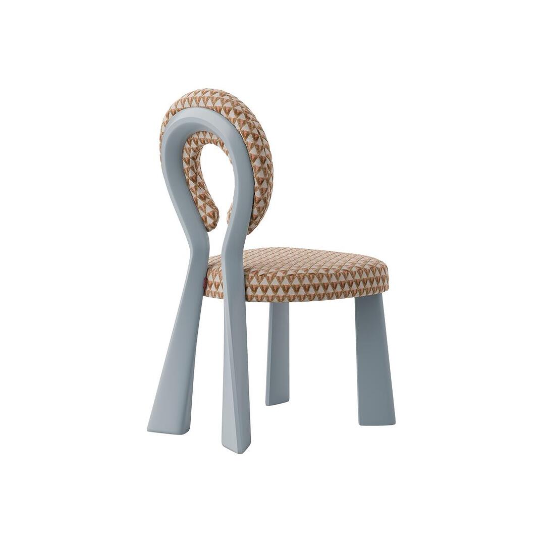 Three-quarter rear view of the Mary Dining Chair with a matte light-blue upholstered frame and a terracotta-toned geometric patterned seat.