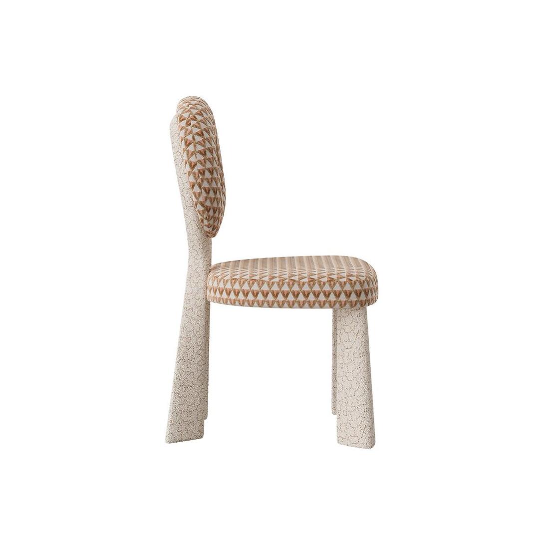 Profile view of the Mary Dining Chair, illustrating the clean, vertical lines of the backrest and the generous padding of the seat.