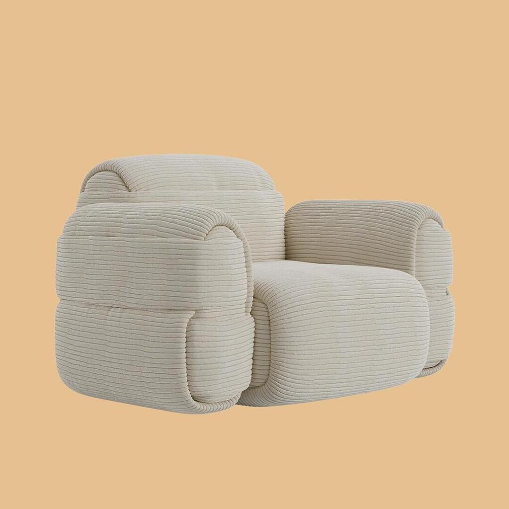 The Elsa Modular Armchair, shown from a slightly angled perspective. The chair boasts a bulky, bulbous design with thick, curved armrests and is uniformly upholstered in an off-white, horizontally ribbed fabric.
