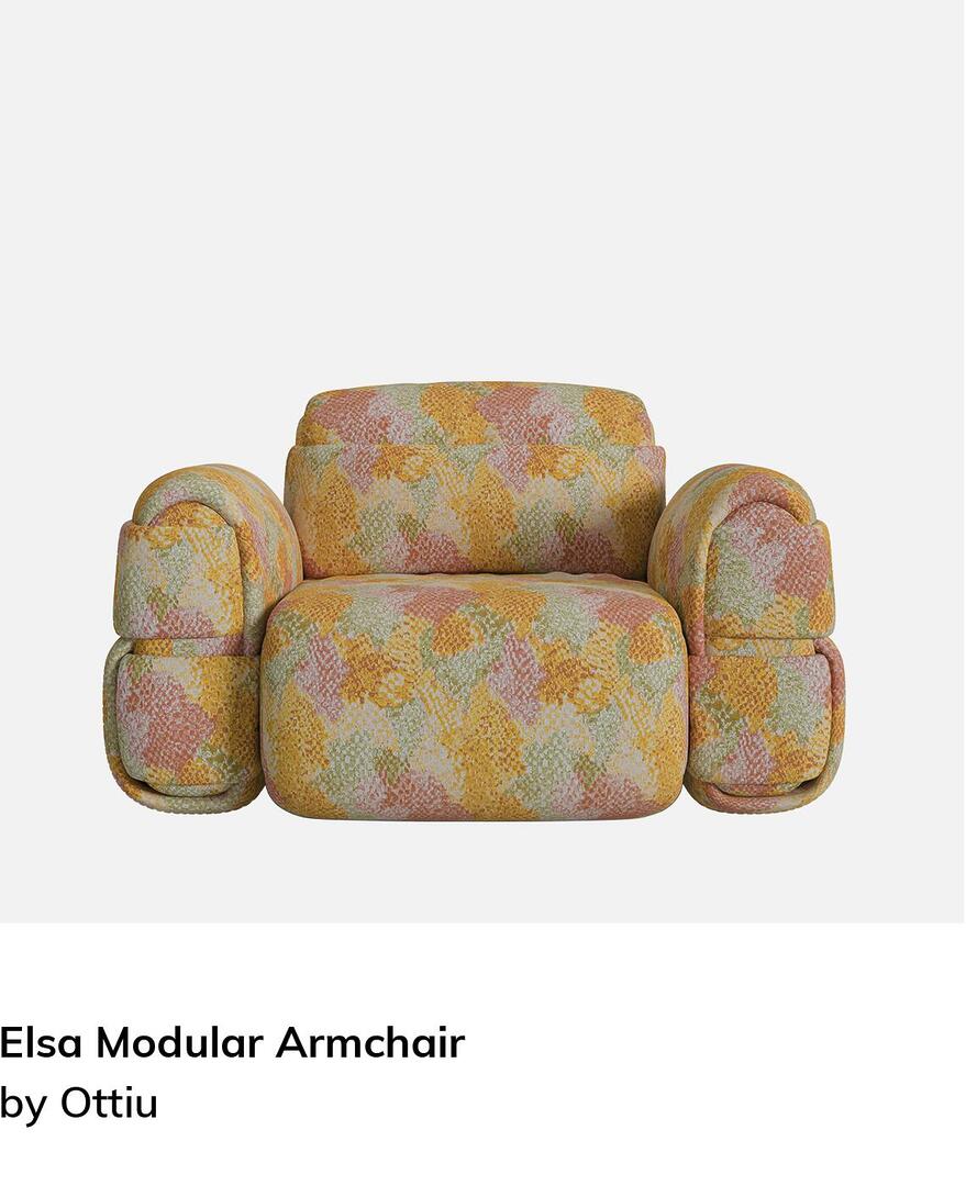 The Elsa Armchair, a bold and sculptural lounge chair featuring a voluminous, rounded design. Entirely upholstered in a vibrant, multi-colored patterned fabric with shades of yellow, orange, and green, the chair boasts oversized, cushioned armrests and a thick seat, giving it a cozy yet avant-garde aesthetic.