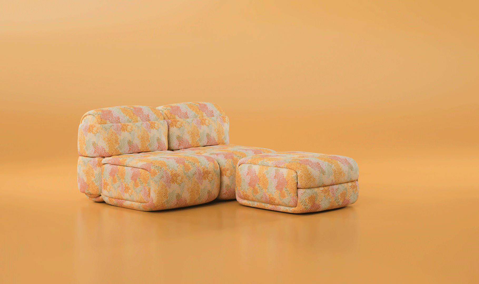 An animated GIF showcasing the versatility of the Elsa Modular Sofa. The animation demonstrates individual pieces—including the Elsa Ottoman, Elsa Modular Armless Chairs, and end modules with thick armrests—sliding together sequentially to form a large, continuous seating arrangement. All components feature a voluminous, rounded design and are uniformly upholstered in a textured fabric with a colorful geometric mosaic pattern in warm shades of yellow, coral, peach, and sage green.