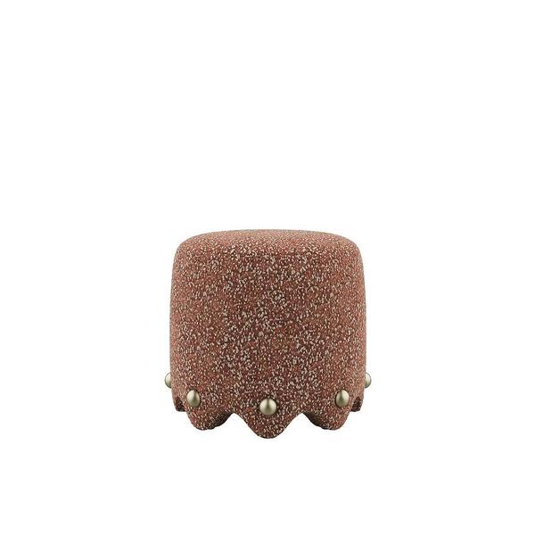 A front-view studio shot of the Bette Stool by Ottiu, featuring a robust, cylindrical silhouette upholstered in high-tactile Élitis Mochi fabric in a rich rust tone. The base is defined by a sculptural, scalloped hemline punctuated with spherical polished brass studs.