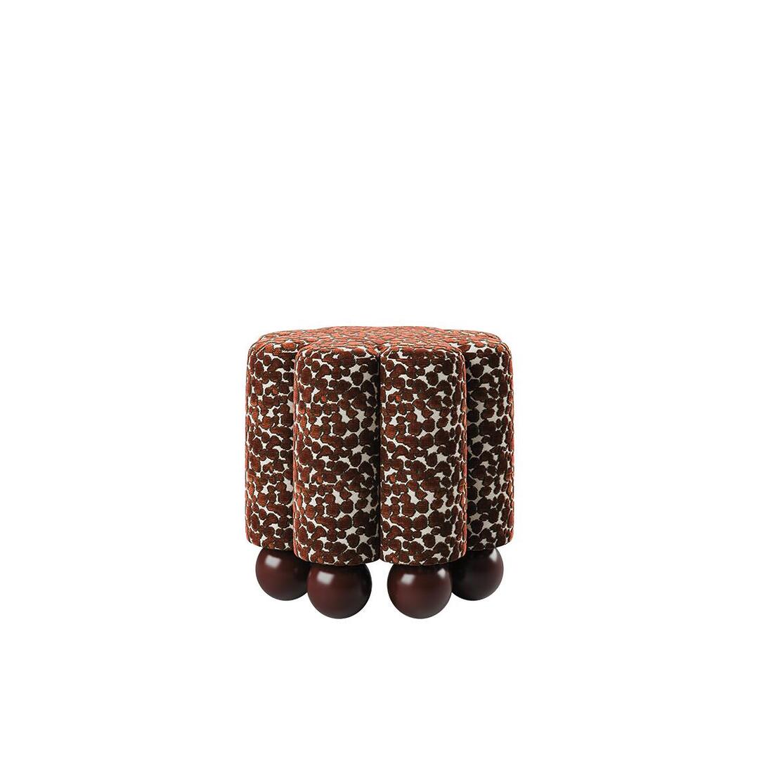 Side view of the Myrna Stool featuring a series of tailored vertical tubes upholstered in Misia Niki patterned velvet, supported by a base of solid lacquered wood spheres.