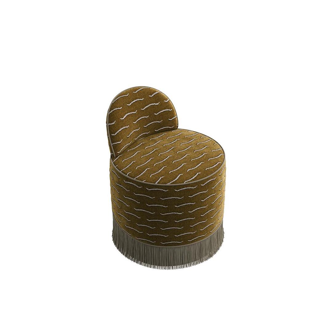 A high-angle view of the primary section of the Lila Stool by Ottiu, shown without the nested ottoman. The standalone stool features a fully round seat, a curved low backrest, gold jacquard patterned upholstery, and a cascading cream fringe skirt around the circular base.