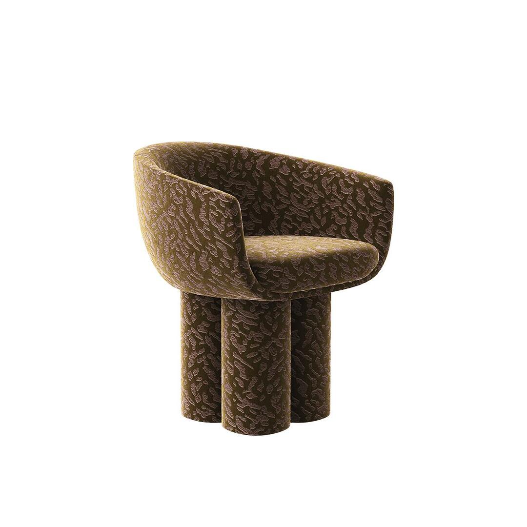 A three-quarter view of the Mae Dining Chair, fully upholstered in the dark Zimmer + Rohde - Bliss - 11037845 fabric. The image highlights the chair's bold, hourglass-inspired silhouette and robust base, textured with a rich, organic jacquard pattern.