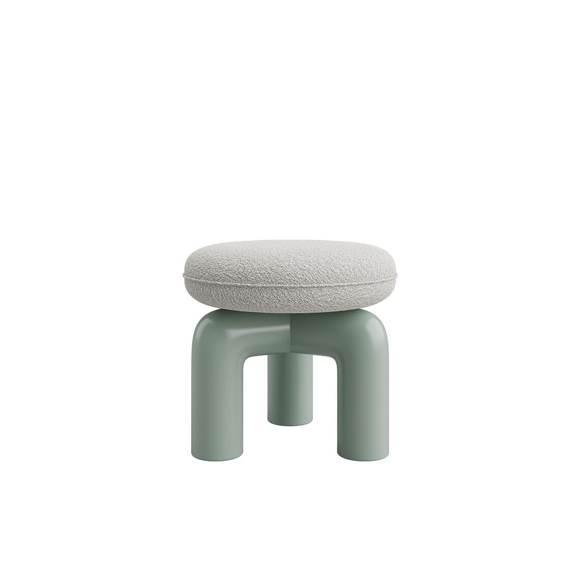 Straight-on eye-level view of another variation of the Tamara Stool by Ottiu. This version showcases a highly tactile, light cream or off-white bouclé or textured fabric seat cushion. The sculptural base underneath is finished in a smooth, glossy sage green lacquered wood with thick, curved tubular legs.