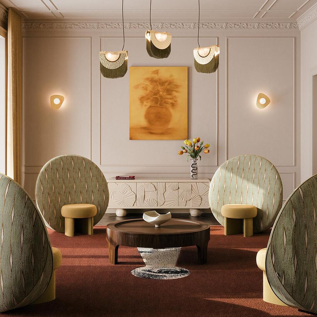 A luxurious mid-century modern living room setting featuring four Ottiu Solène Armchairs arranged around a round dark wood coffee table on a terracotta rug. The armchairs showcase a unique design with large, circular, patterned green fabric backrests and small, round yellow velvet seats. In the background, a white textured sideboard stands against a beige paneled wall, complemented by an ochre floral painting, elegant fringed pendant lights, and warm wall sconces.
