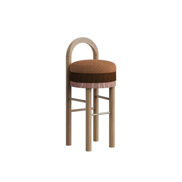 Three-quarter view of the Ann Bar Chair featuring natural wood legs, a decorative weave pattern seat cushion, layered brown and pink fringe details, an arched wooden frame backrest, and a stainless steel footrest.