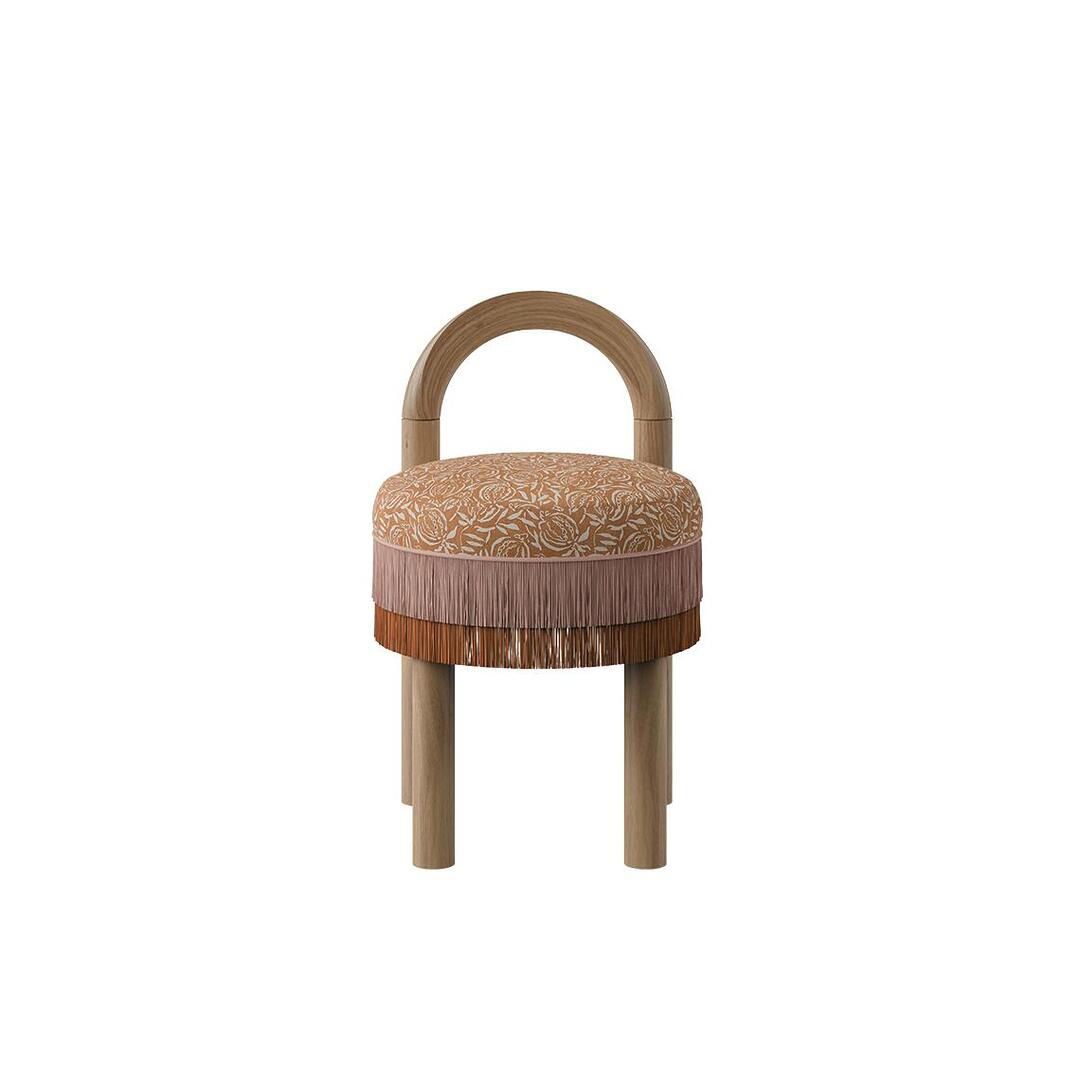 Front view of the Ann dining chair featuring an arched natural wood backrest and legs, paired with a round seat in decorative weave fabric and layered decorative fringes.